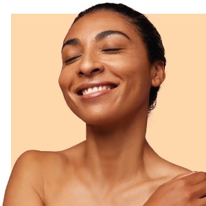 A woman smiling after having a MD Power-C Peel.
